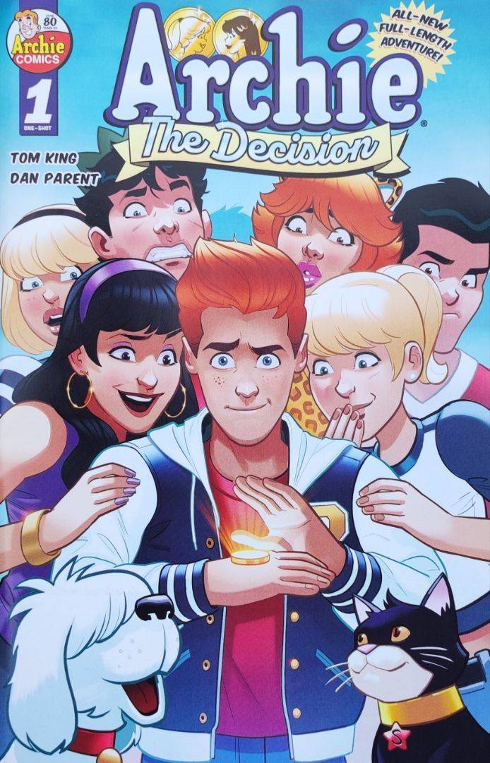 Couverture du comic-book Archie : The Decision. On y voit un adolescent rouquin entouré par des filles et des garçons. Il a une pièce posée sur le dos de la main, il vient de tirer à pile ou face qu il préfère entre Betty et Veronica, ses deux amoureuses.