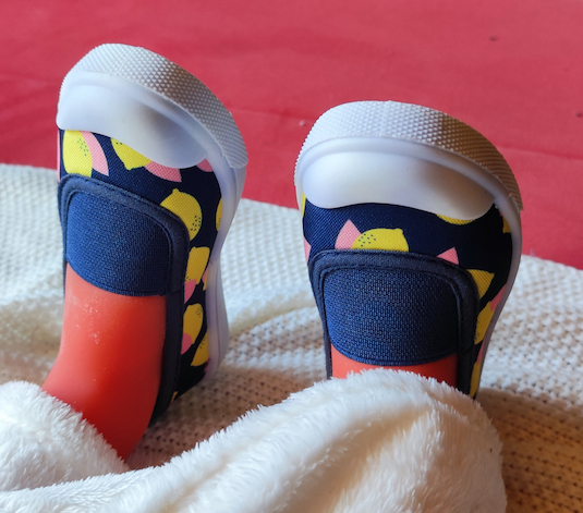 photo en gros plans de petites chaussures bleues avec des petits citrons jaunes imprimés dessus.